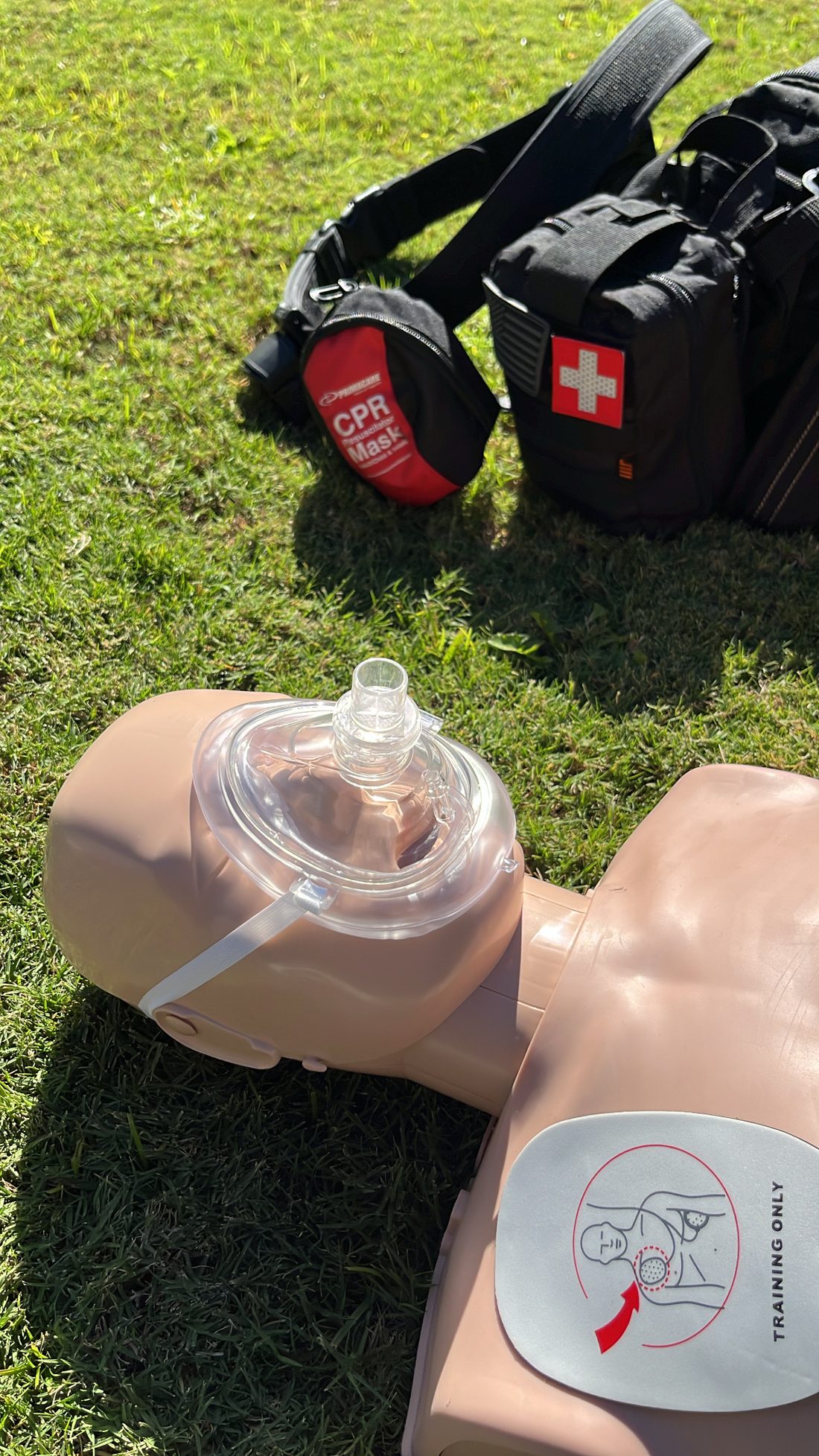 Hands-on CPR training on a mannequin with a CPR mask